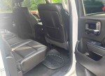 Interior view of a 2014 GMC Sierra 1500 with spacious black leather seats and an open rear door.