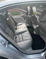 Interior view of 2012 Honda Accord EX-L V-6 showing spacious rear leather seats, ideal for comfort.