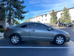 2008 Honda Civic LX in gray, parked, showcasing its clean body and smooth lines.