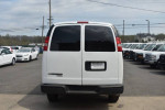 Rear view of a 2016 Chevrolet Express cargo van in a parking lot with several other vehicles