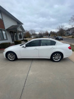 2009 Infiniti G37 RWD in white, parked outside a house with no visible damage, well maintained.