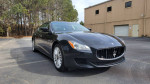 2014 Maserati Quattroporte S Q4 in black, parked in a clean lot, showcasing its sleek design and premium features.