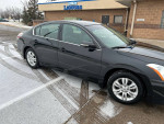 2012 Nissan Altima 2.5 FWD, black sedan parked, excellent condition, showing slight scratch on passenger door.