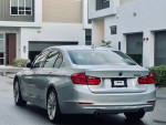 2015 BMW 335 XI AWD Twin Turbo in Frozen Silver Metallic, showcasing a powerful luxury sedan with black leather interior.