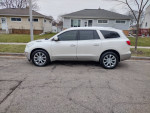 2013 Buick Enclave Limited in white, showcasing stylish exterior and alloy wheels on a residential street.
