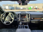 Interior view of a 2016 Ford F-150 Platinum with high-tech dashboard and leather seats