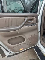 Interior view of the door of a 2002 Toyota Sequoia, showcasing its functional design and features.