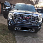 Front view of a 2022 GMC Sierra 1500 Denali 4WD in immaculate condition with the door open.
