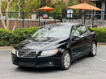 2009 Volvo S80 in black parked with a clean exterior and beige leather interior for sale.