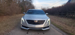 2018 Cadillac CT6 Luxury sedan in silver with prominent grille and stylish headlights on a country road
