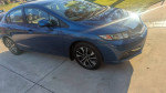 2013 Honda Civic EX in blue color parked on the driveway, showing its sleek design and modern features.