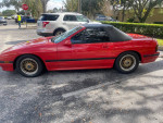 1988 Mazda RX7 in excellent condition, red convertible with manual transmission, parked in a well-maintained area.