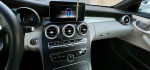 Interior view of a 2017 Mercedes-Benz C300 Cabriolet, showcasing premium features and tech display.