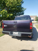 Rear view of a 2007 Ford F-150 Harley-Davidson in dark amethyst color with minor wear.