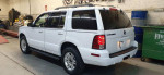 2005 Mercury Mountaineer in white color with beige interior parked in a garage, showcasing its exterior and four good tires.