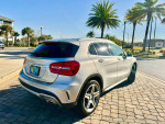 2015 Mercedes-Benz GLA 250 4MATIC SUV parked on a sunny day, showcasing its stylish rear and vibrant surroundings.