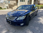 2010 Lexus LS460 AWD in blue parked on the driveway, showcasing its smooth design and excellent condition.
