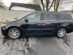 2011 Honda Odyssey EX FWD black minivan with power sliding doors parked on a snowy street
