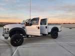 2009 Ford F250 Superduty Lariat Diesel with 160k miles and lift kit parked outdoors