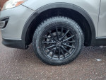 Close-up of the black alloy wheel and tire of a 2010 Mazda CX-9 Grand Touring SUV.