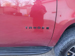 Close-up of 2007 Chevrolet Tahoe badge, showcasing red exterior and vehicle condition.