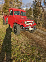 1951 Willy's Jeep Pickup Truck in red with original features parked on a grassy path