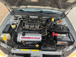 Nissan Maxima SE engine view, showing V6 3000 motor and battery, well maintained with low mileage.