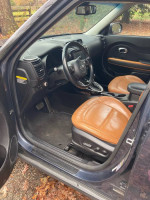 Interior view of a 2016 Kia Soul showcasing leather seats and dashboard features.