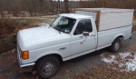 1991 Ford F150 truck with an 8-foot bed and side boards, parked in a rural area with a winter backdrop.