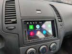 Interior of a car featuring Android Auto and Apple CarPlay interface on the dashboard.
