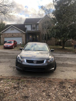 Front view of a gray 2008 Honda Accord with 75,000 miles, parked outside a house.