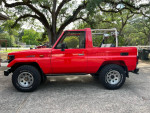 1993 Toyota Landcruiser BJ FJ 73 4X4 in red, showcasing a clean exterior and rugged tires.