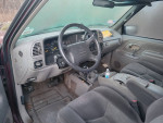 Interior view of a 1996 Chevrolet Silverado 1500, showing dashboard and seating area with minor wear.