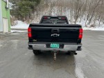 Rear view of a 2015 Chevrolet Silverado 1500 LTZ 4WD showcasing its clean body and rear rack.
