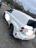 2010 Chevrolet HHR LS FWD parked, previously a delivery car, showing wear and tear, perfect for budget gas savings.