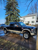 2008 Ford F350 King Ranch Super Duty truck with 151K miles, high performance and solid frame, parked outdoors.