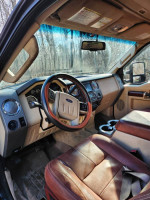 Interior view of a 2008 Ford F350 King Ranch with leather seats and customized features.