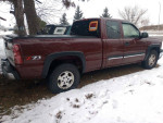 Maroon 4x4 Chevrolet Silverado 1500 parked in snow, featuring clean exterior and 8ft bed.