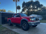 2003 Toyota Tacoma Pre-Runner in radiant red, equipped with SR5 and TRD Off-Road packages.