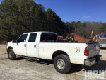 2016 Ford F-250 XL 4x4 Crew Cab with 8 ft bed parked in a worksite, ideal for heavy-duty tasks.