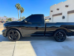 2015 Ram 1500 R/T truck in black with 22-inch wheels, supercharged HEMI engine, parked outdoors.