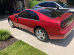 1990 Nissan 300ZX in red parked on driveway, showcasing its sleek styling and condition.
