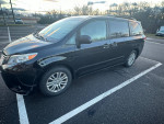 2014 Toyota Sienna XLE in black with minor body damage parked, front and rear tires and brakes are new.