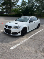 2015 Chevrolet SS parked, white exterior, custom modifications visible, showcasing performance upgrades.