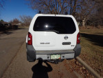 Rear view of a 2002 Nissan Xterra 4x4 parked on a street, showcasing its clean design and off-road capability.