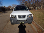 2002 Nissan Xterra in white, showing front view, ideal for off-road adventures and skiing, private sale.