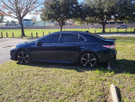 2020 Toyota Camry XSE in Galactic Aqua color parked on grass with stylish black rims