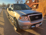 2004 Ford F150 XLT with new engine and tires, showing minor rust and with custom wheels.