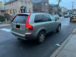 2007 Volvo XC90 parked on street, features leather seats, sunroof, and third-row seating.