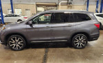 2019 Honda Pilot Touring FWD in blueish-grey with black leather interior on display at dealership